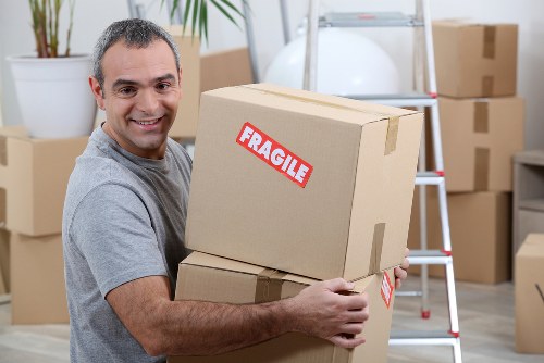 Student removals team planning a move in Knightsbridge with boxes and a small van