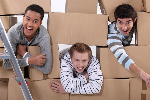 Moving team handling desks and office furniture in central London