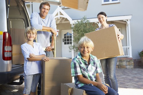 Professional movers handling household furniture in a Knightsbridge property
